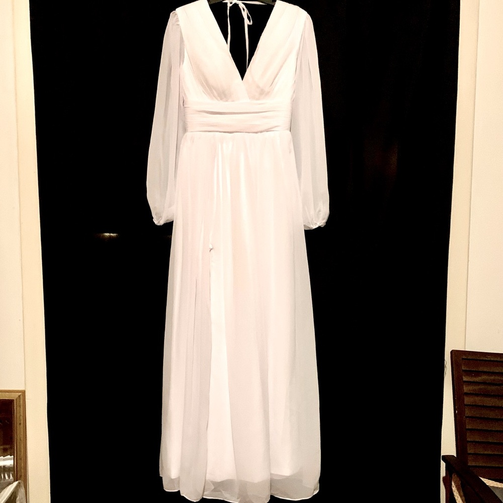 Long sleeve white wedding gown with side slit and lace up back. Size US 10